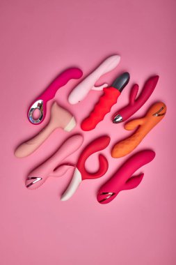 Flat lay red and pink cute dildo smooth vibrators