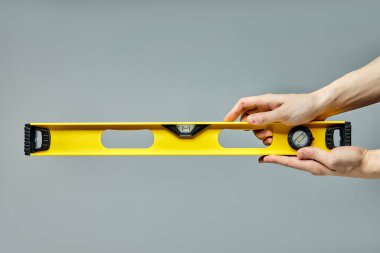 yellow spirit level, bubble level designed to indicate whether a surface is horizontal or vertical clipart
