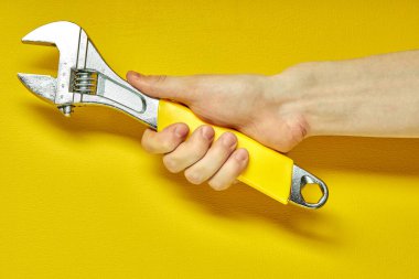 Ayarlanabilir metal anahtar ellerde. Arkaplan pankartı, poster ve daha fazlası için ayarlanabilir metal anahtar.