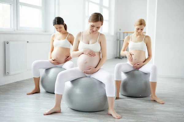 relaxed pregnant women lead active healthy lifestyle, going for yoga fitness sport