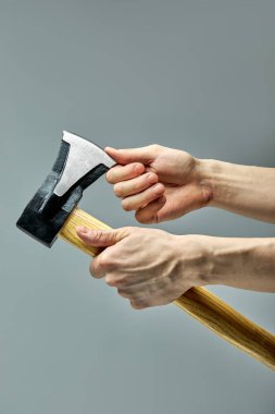 Marangozluk atölyesinde çalışan Kırpılmış Adam, balta kılıcının keskinliğini kontrol ediyor.