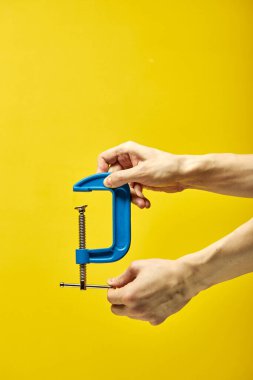 mavi c-klemp veya G-klemp, sarı arkaplan üzerinde izole