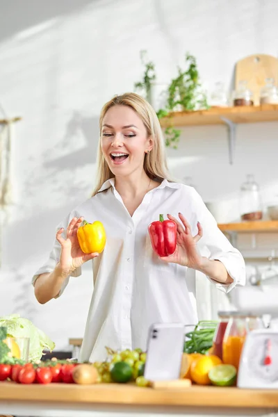 Positive young woman food blogger talking recording video while cooking, vlog concept