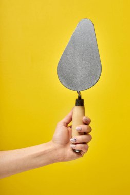 Sarı arkaplanda izole edilmiş metal spatula