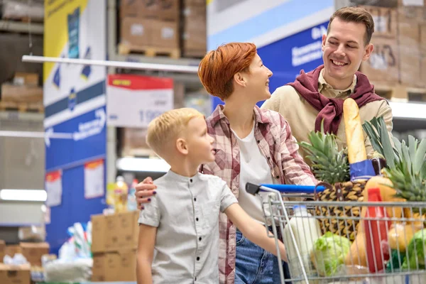 W supermarkecie: Szczęśliwa Para Ciesz się czasem zakupów z rodziną podczas spaceru po sekcjach sklepu. — Zdjęcie stockowe