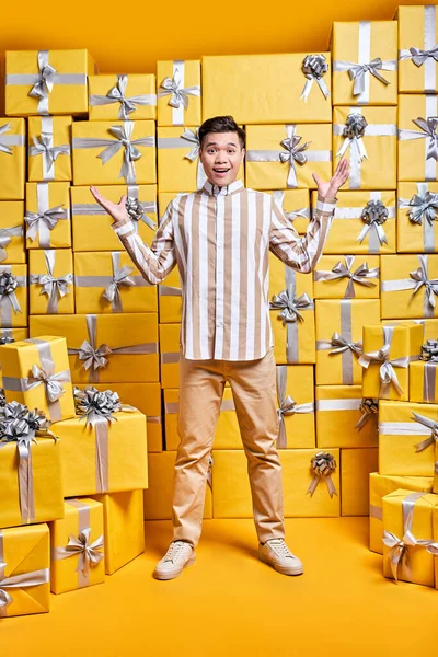 Cheerful Chinese Guy In Casual Shirt Is Surprised By Getting Many Gifts For Birthday