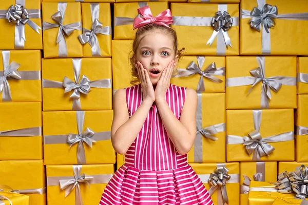 Linda niña emocional en shock, sorprendida por ver tantos regalos — Foto de Stock
