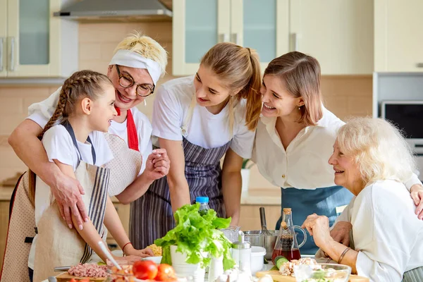 Beautiful caucasian women, grandma and children posing looking at camera, portrait