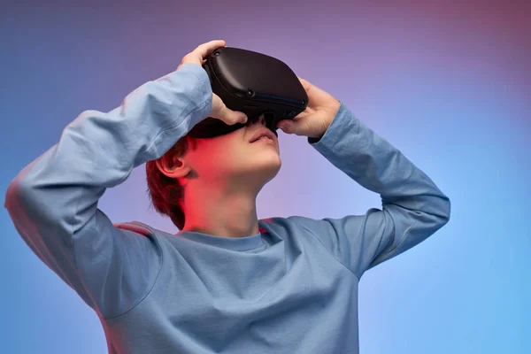 Incroyable adolescent garçon portant des lunettes de réalité virtuelle regarder des films ou jouer à des jeux vidéo — Photo