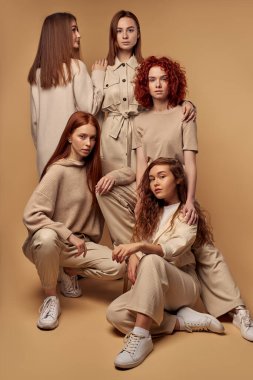Moda haftası kıyafetleri içindeki beyaz saçlı genç mankenler tek başlarına poz veriyorlar.