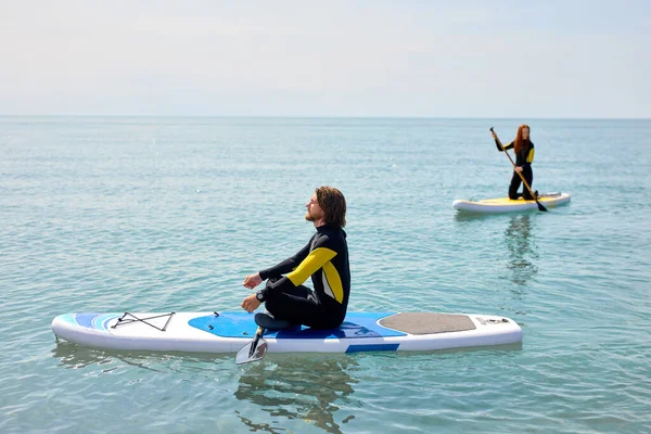 Paddleboard-Strandmenschen auf Stand-up-Paddle-Brettern ruhen sich nach dem Surfen aus — Stockfoto