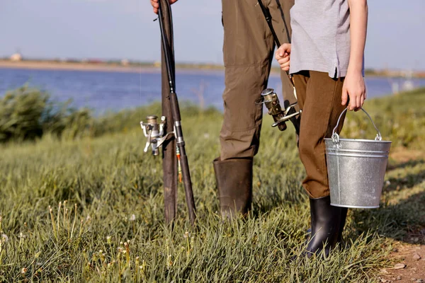 Grandpa impressed by fish preschool grandson caught. Cropped child and man with bucket — Stock Photo, Image