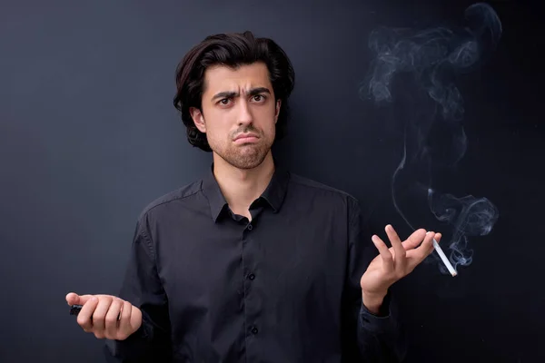 man holding cigarette in hands, misunderstanding, Isolated on black studio background