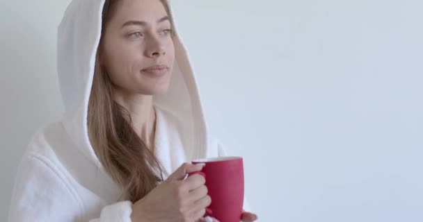 Zrelaksowana kobieta w szlafroku pijąca kawę, ciesząca się poranną rutyną, przygotowująca się do dobrego dnia — Wideo stockowe