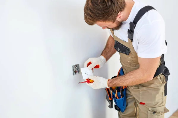 Close-up Of Persons Hand Installing Socket On Wall At Home, Repairman In Overalls Using Tools — Fotografia de Stock