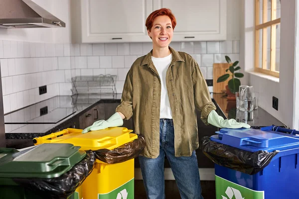 Woman sorting garbage. Nice female separate waste and throwing trash into recycling bins — Fotografia de Stock