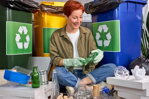 Happy woman sorting different waste. Sorting waste paper, glass, plastic into box — Stockfoto