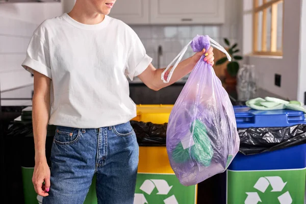 Woman throws garbage bag in the trash sorting waste, cropped photo of woman in casual wear — Stockfoto