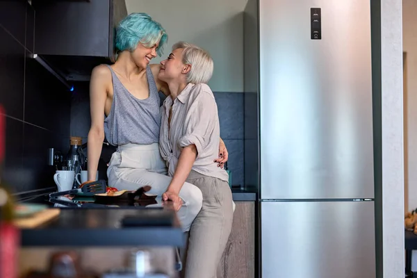 Pretty Same Sex Young Female Couple Hugging Kissing In Kitchen At Home Together — Stock Fotó
