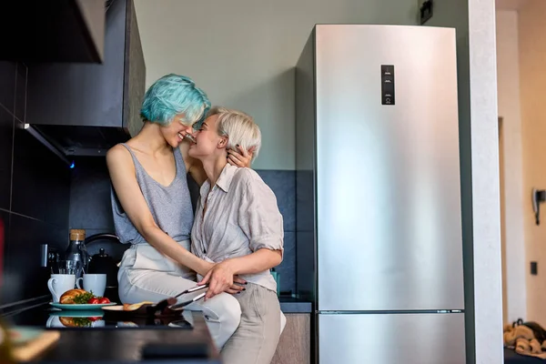 Loving Same Sex Young Female Couple Hugging Kissing In Kitchen At Home Together — Stock Fotó