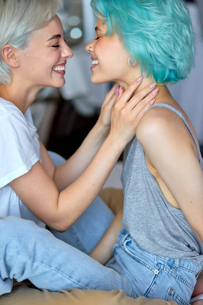 Caucasian lesbian LGBT Couple warm hug on bed in bedroom with laughing moment — Stock Photo, Image