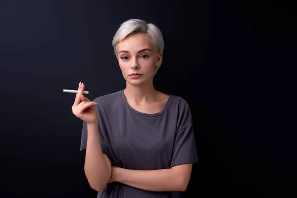 Confident woman holding Cigarette in hands. Cigarettes or tobacco, isolated on black — Fotografia de Stock
