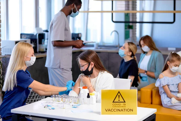 Vaccinering av personer på läkarmottagningen. Spruta med vaccin mot covid-19 coronavirus — Stockfoto