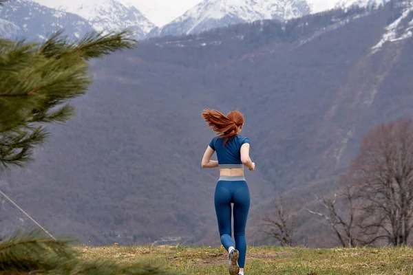 慢跑对积极的生活方式跑步者来说是健康的。穿着运动服的红头发女人 — 图库照片