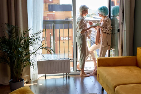 Lesbian, couple, romance concept. two lesbian women have breakfast on balcony — Stock Photo, Image