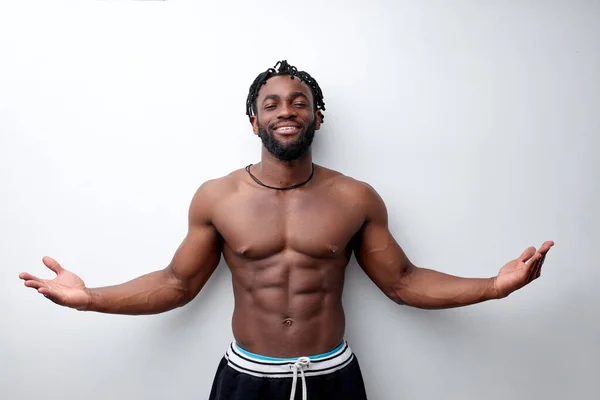 Fit young man with beautiful torso, isolated on white background, spreading arms — Stock Photo, Image