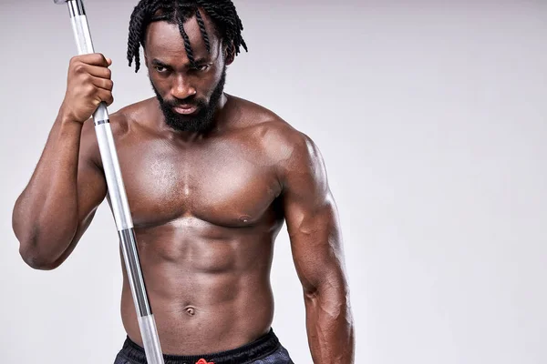 Aggressive bearded african muscular Man with barbell weight, sport equipment — Stock Photo, Image