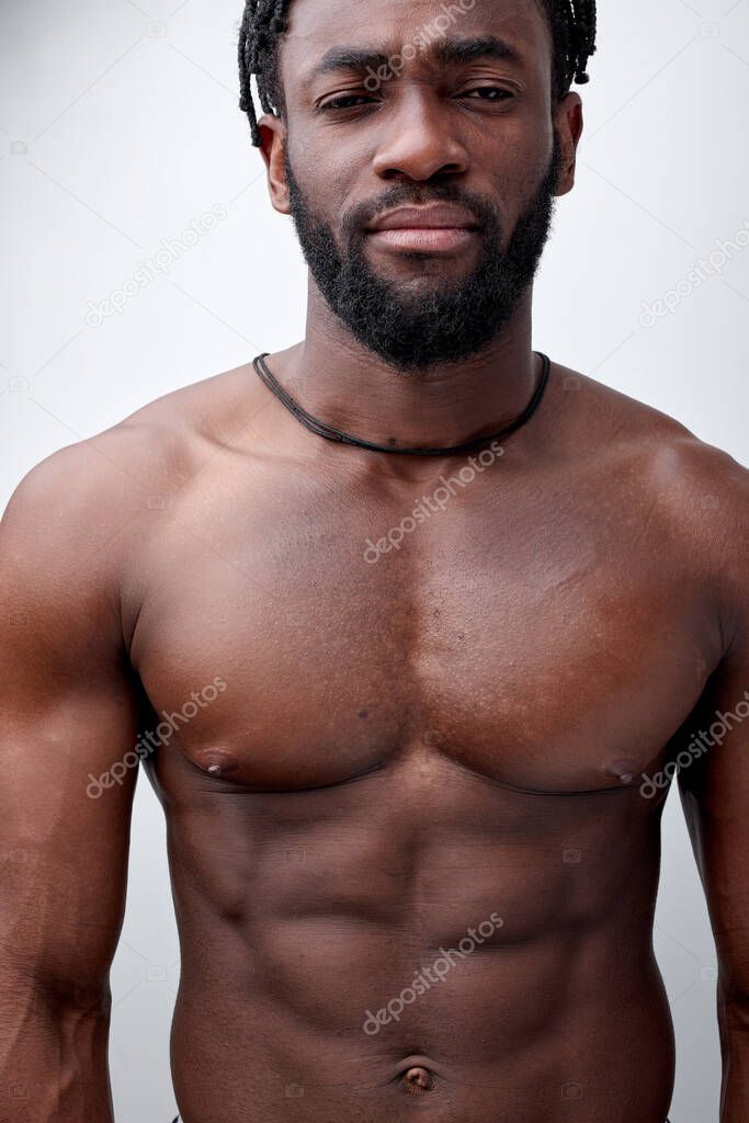 Serious and thoughtful naked african american young man isolated on white