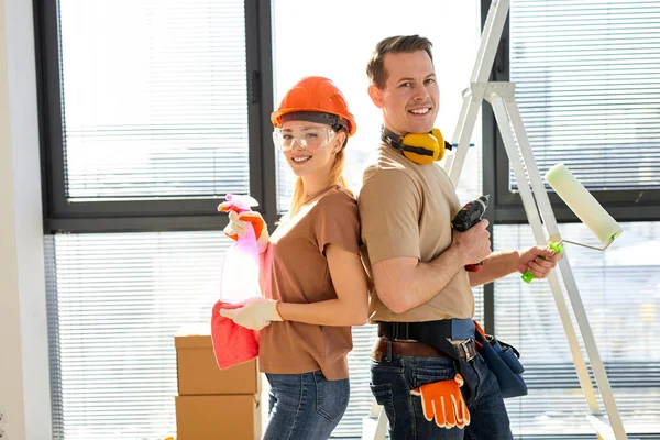 Feliz jovem caucasiano casal fazendo reparação em nova casa aprtment, segurando ferramentas — Fotografia de Stock