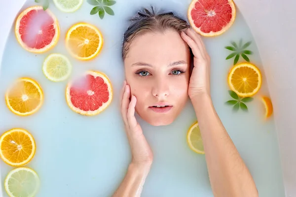 Vista dall'alto sulla donna sdraiata nel bagno di latte con frutta. Cleopatras Bagno. — Foto Stock