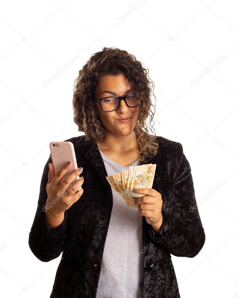 Woman with curly hair is checking smart cell phone and holding a