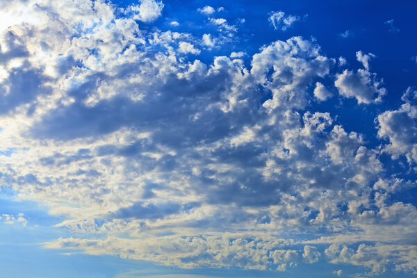 Blue sky with clouds covering the sun. Can be used as background