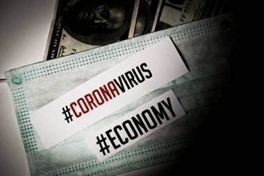 Corona virus impact on European economy and American economy concept, banknotes with medical mask and text