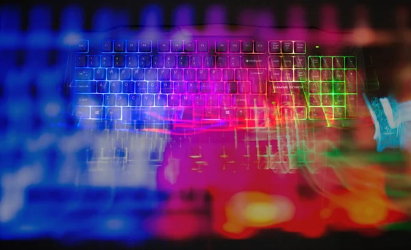 Gaming keyboard with led lights leak on black background