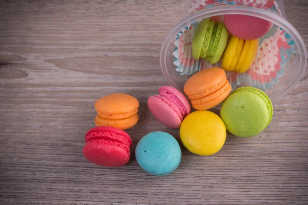 Sweet colorful macaroons on a wood background — Stock Photo, Image