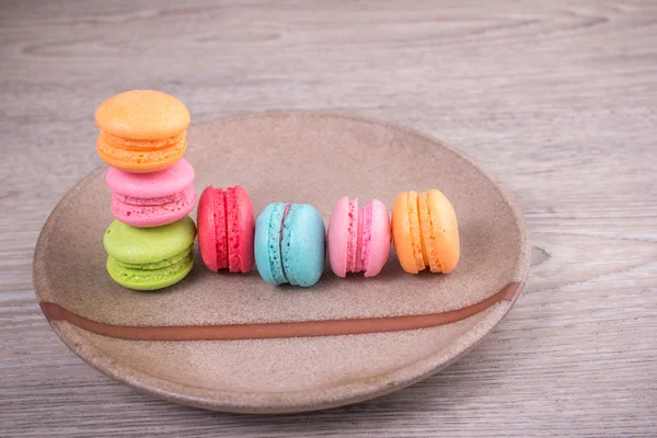 Sweet colorful macaroons on a wood background — Stock Photo, Image