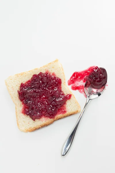 Toast with cherry jam and spoon — Stock Photo, Image