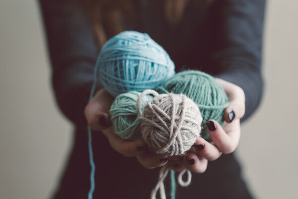 Holding a balls of yarn