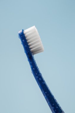 Blue toothbrush with water drops clipart
