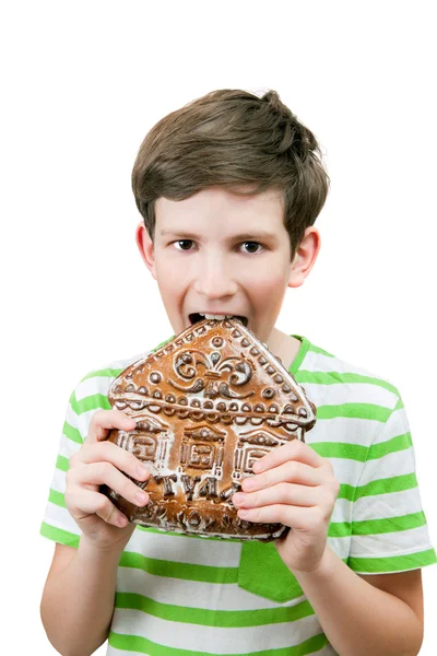 Boy eats big gingerbread — Stock Photo, Image