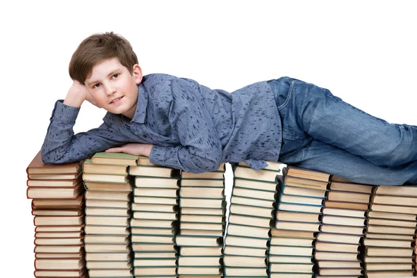 Student lying on books — Stock Photo, Image