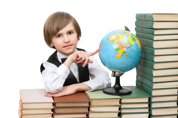 Menino em pilhas de livros antigos — Fotografia de Stock