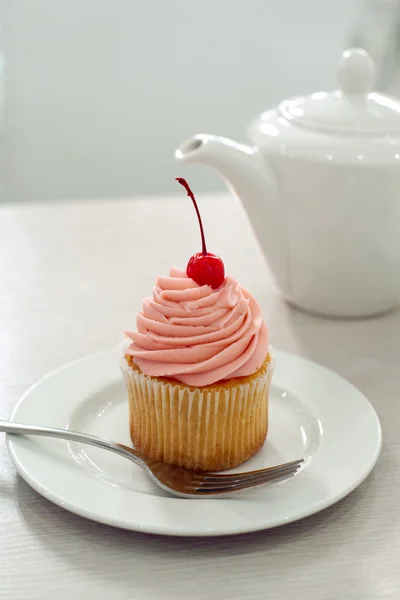 Cupcake with cherry on table — Stock Photo, Image