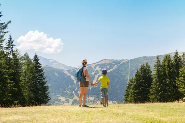 Kobieta i chłopiec chodzenia w górach — Zdjęcie stockowe