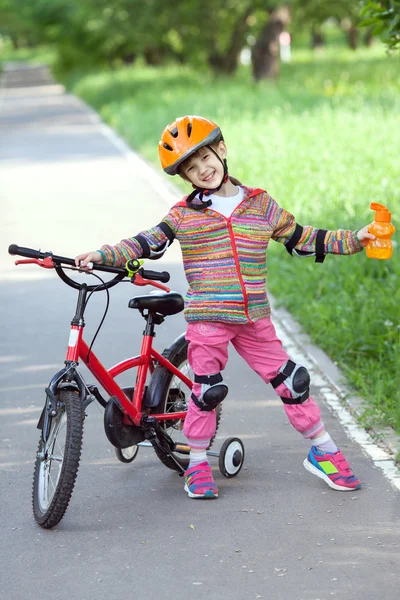 Little girl with a bike — Stock Photo, Image