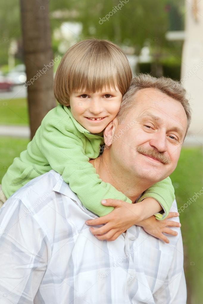 Boy embraces man